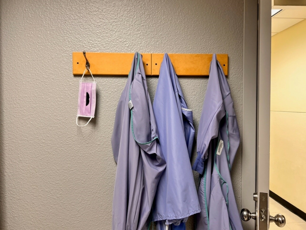 scrubs hanging on wall