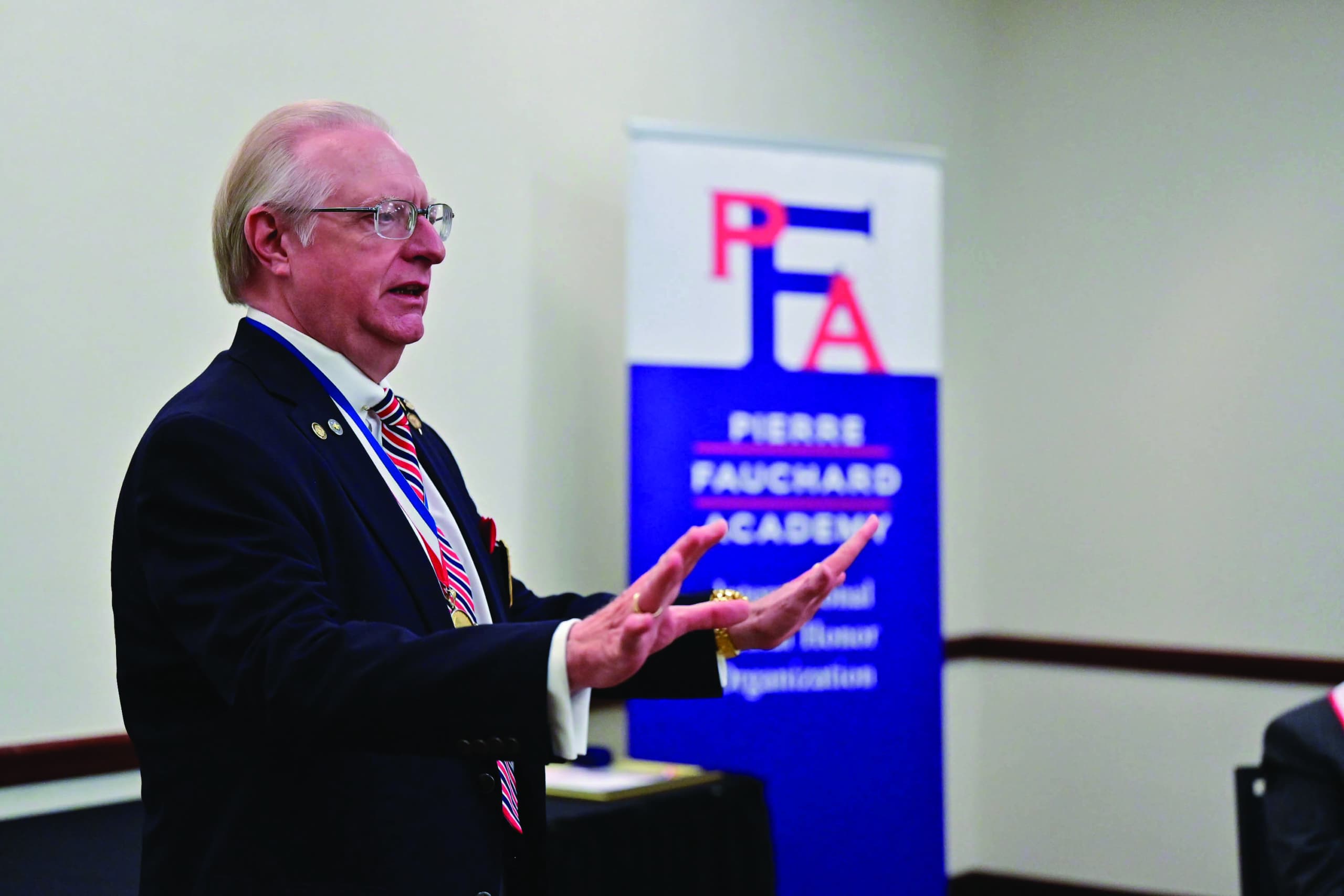 Hal Hale speaking at podium