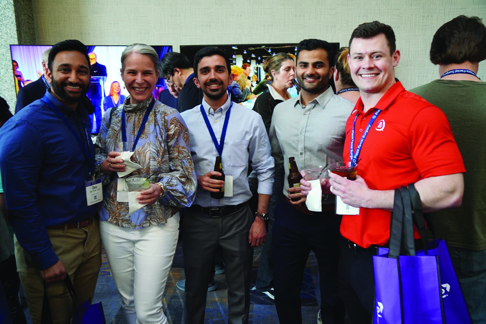 group.of five alumni at reception
