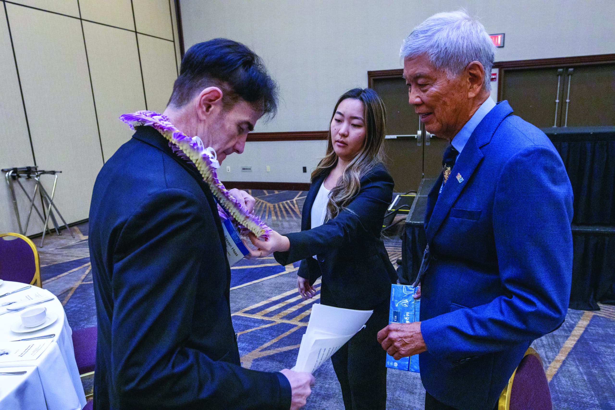 Dr. Russell Tabata presenting alei to a student