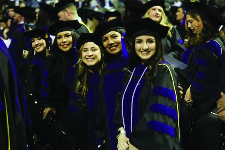 Group photo of graduates in cap and gown