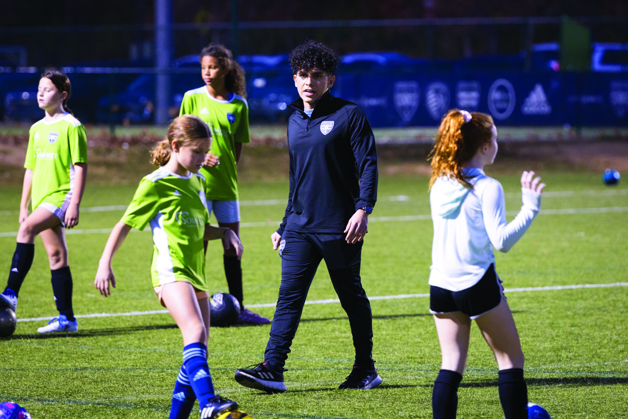 Edgardo Leiva on soccer field with children