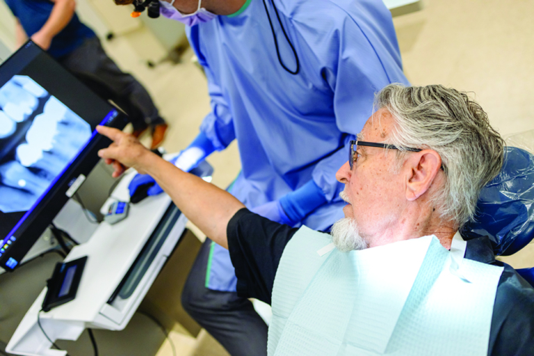 patient in chair pointing at xray