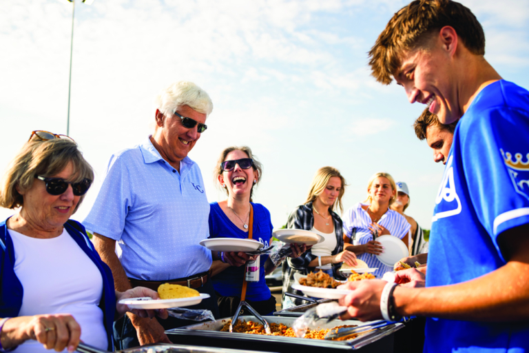group photo of people in line of food buffet